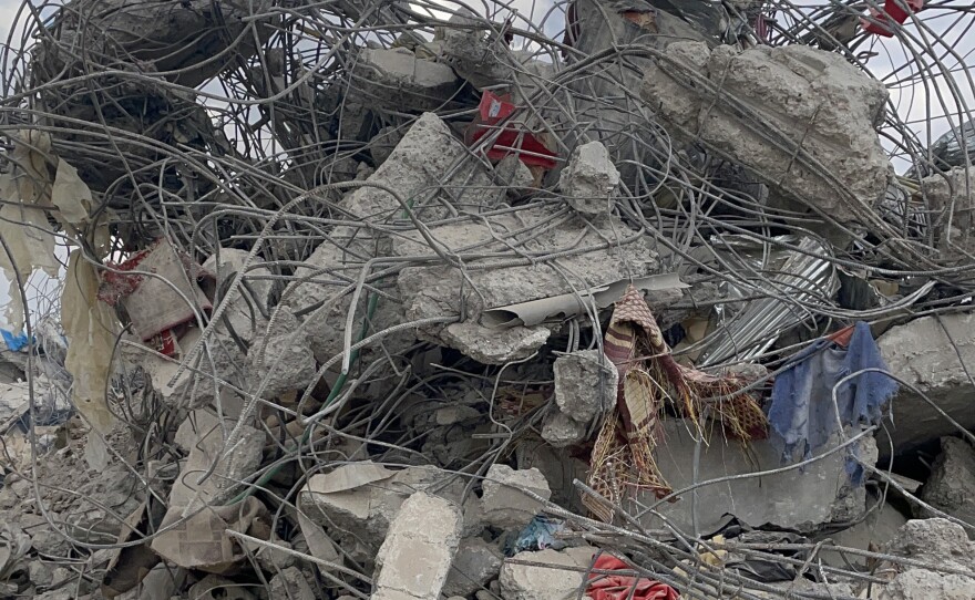Personal possessions are seen on Friday in Jinderis, Syria, amid the tangle of rubble of a destroyed building.
