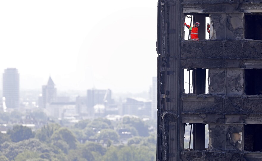 Emergency service workers probe the remains of Grenfell Tower in London on Saturday. City police have announced 58 people remain missing and "we assume likely to have died."