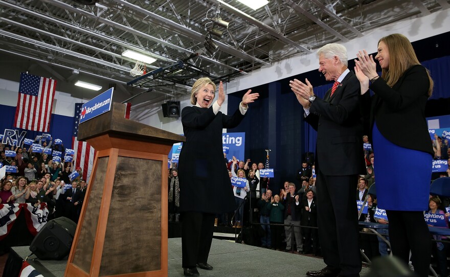 Democratic presidential candidate Hillary Clinton arrives onstage for her primary night gathering with her daughter, Chelsea Clinton, and husband, former President Bill Clinton, at Southern New Hampshire University in Hooksett, N.H.