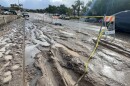 Cars drive by mud and pools of water following Monday's storm. San Diego, Calif. Jan. 23, 2024.