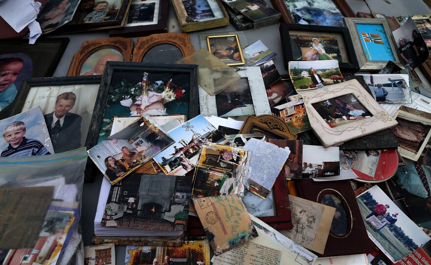 Old photographs are laid out on a car hood to dry after being removed from a flooded home in Seaside Heights, N.J. At the time, New Jersey Gov. Chris Christie estimated that Superstorm Sandy had cost his state $29.4 billion in damage and other economic losses.