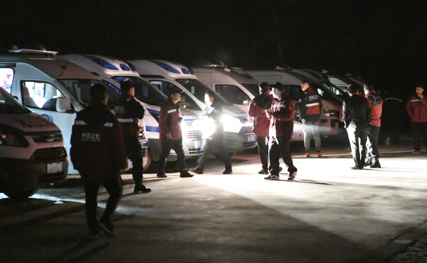 Eemergency personnel and vehicles wait on standby at the Yellow River Stone Forest tourist site in Baiyin in northwestern China's Gansu Province, Sunday, May 23, 2021.