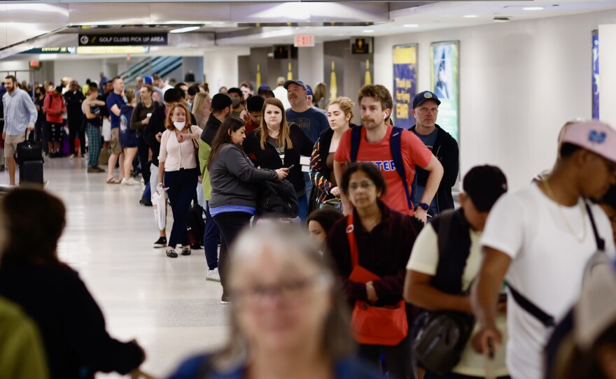 People queue for rescheduled flights at Newark Liberty International Airport in New Jersey on Tuesday.
