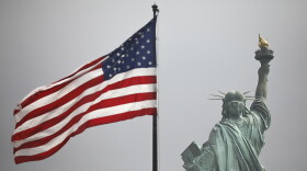 An America flag flies near the Statue of Liberty on Liberty Island on Aug. 14, 2019 in New York City.