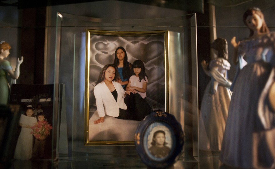 A framed picture of Lily with her two girls at her home in Bend, Ore. Lily left the picture and her kids — Brian, Ashley and Karleen — with a relative when she was deported to Mexico. "