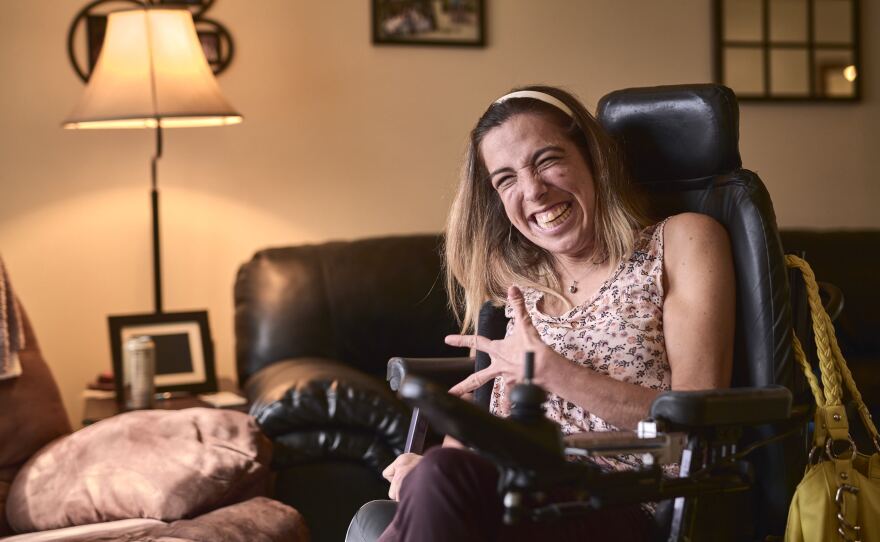 Stacy Ellingen, seen here at her home, in Oshkosh, Wis., says her right to vote is in jeopardy if her caregivers are banned from placing her absentee ballot in the mailbox on her behalf.