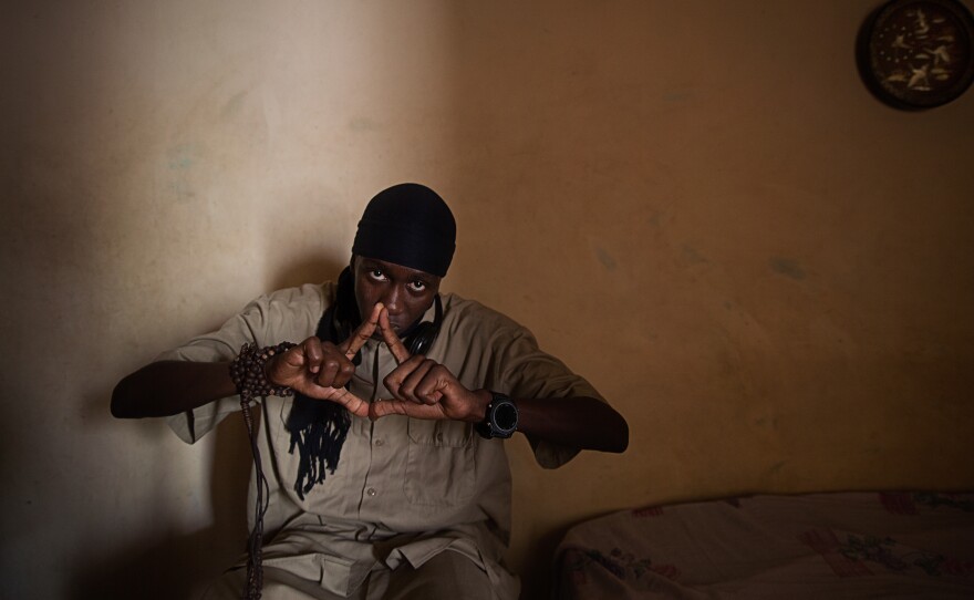 Zendang, a rapper from Mauritania, in his bedroom in Dakar. Below: Rappers perform on a small outdoor stage.