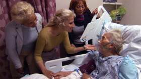 The Laureville family visits with 86-year-old mother and grandmother Marthe, moments after doctors took her off a respirator.