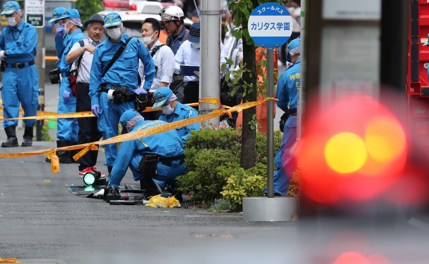 Police forensic experts investigate a crime scene where a man stabbed 19 people, including children in Kawasaki on May 28. Two people, including a child, are reportedly dead.