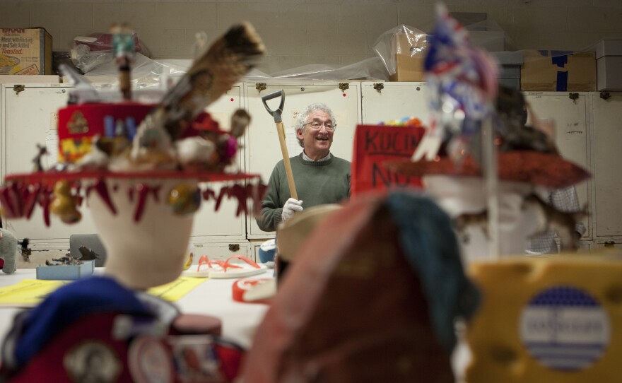 Rubenstein holds an old shovel that was used during a presidential campaign at the National Museum of American History. The shovel was used to clear snow away from people's front yard then left as a campaigning advertisement.