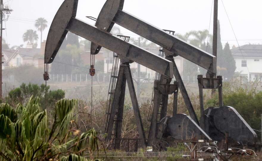 An oil pumpjack operates as another stands idle on March 28 in Los Angeles. U.S. oil producers face constraints in ramping up oil production.