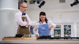 Behind the scenes: Milk Street Cook Lynn Clark (right) shows Christopher Kimball (left) how to make Persian Jeweled Rice, a saffron and orange rice pilaf studded with cranberries and pistachios. 