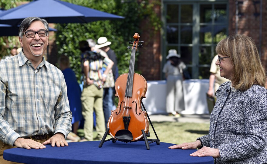 Claire Givens (right) appraises a 1967 Ansaldo Poggi viola, in Woodside, Calif. ANTIQUES ROADSHOW “Filoli, Hour 1” premieres Monday, January 2 at 8/7C PM on PBS.