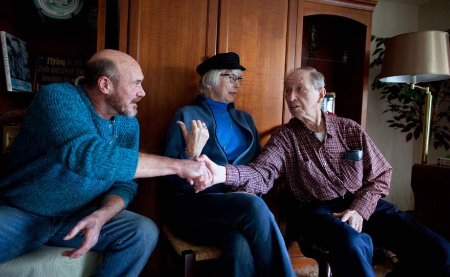 Donnie Lehman (left), Chris Cable and Cyril Syoboda introduce each other before the Make Room concert at Tom Wall's apartment. Lehman used to be homeless, living on the streets, before Wall brought him in as a roommate.
