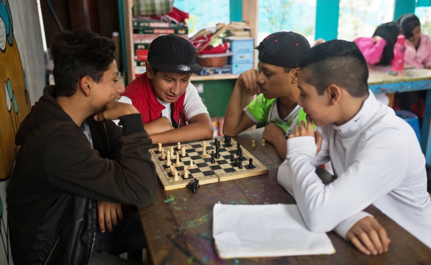 Teenagers play chess during a break at the main Los Patojos campus.