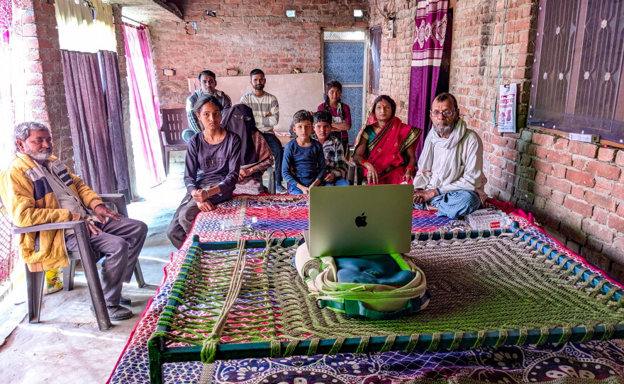 The families of two young men whose friendship inspired the movie Homebound gather for a makeshift screening on the balcony of the home of Mohammad Saiyub.  