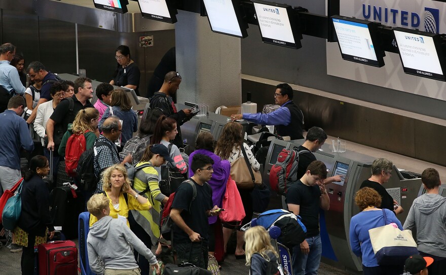 United passengers wait to check in at San Francisco International Airport on July 8, after a computer glitch disrupted flights worldwide. A similar problem grounded flights in June as well.