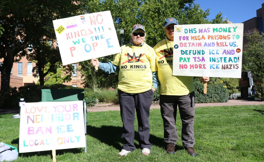 Cheryl Singleton and Sandy Hill of West Point, Utah, hold signs at the No Kings rally outside the Ogden Municipal Building in Ogden, Utah, on Oct. 17.