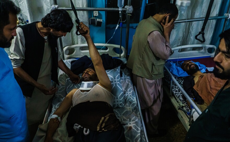 Family members visit wounded patients at the Wazir Akbar Khan Hospital in Kabul, Afghanistan. Dozens of Afghans were killed and more than 140 were injured.
