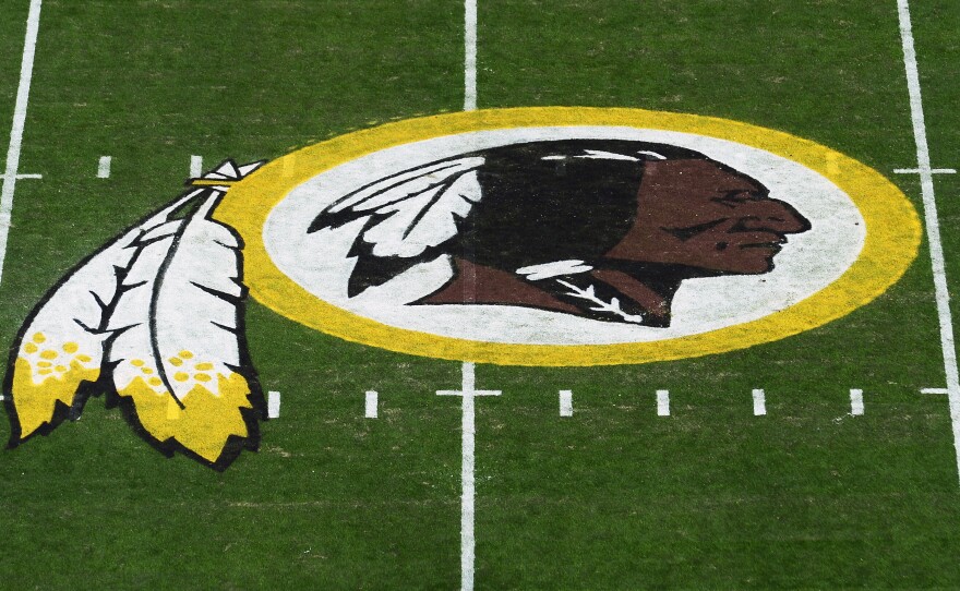 The Washington Redskins' logo is seen before a game in 2019 in Landover, Md. The Redskins have announced the team will be dropping its moniker, which is widely considered a slur against Native Americans.