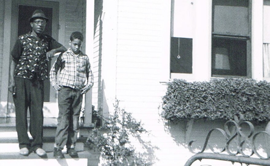 Author Walter Mosley in front of his childhood home in the L.A. neighborhood of Watts. He's standing with his father.