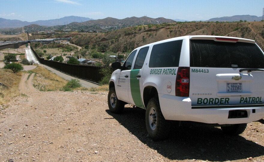 A Border Patrol vehicle patrols the fence separating the cities of Nogales, Ariz., and Nogales, Sonora. The fence has been rebuilt twice.