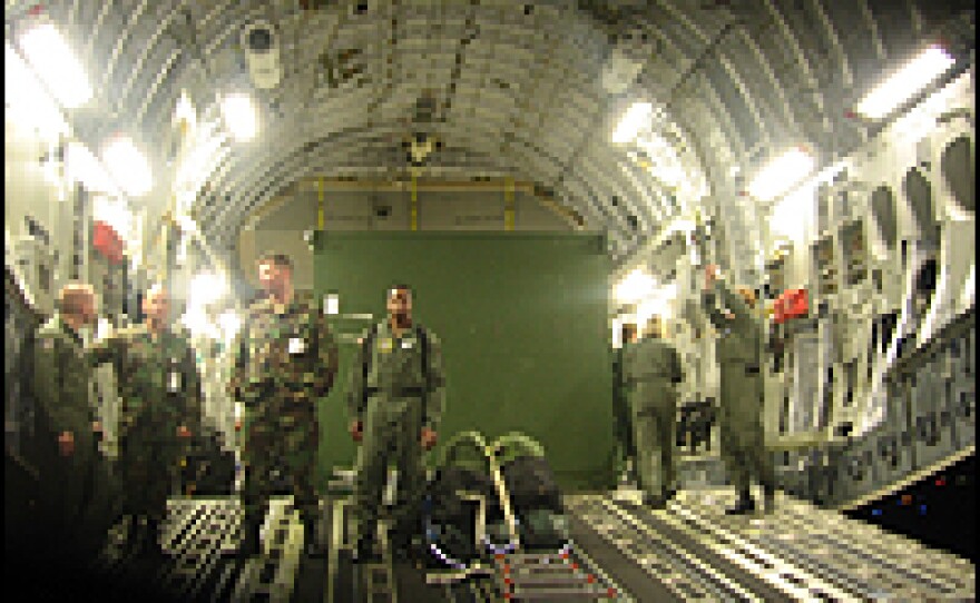 A C-17 cargo plane arrives in San Antonio, Texas, with patients who are transported by ambulance to Brooke Army Medical Center.