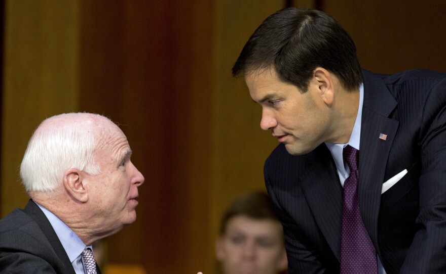 Sen. John McCain, R-Ariz., and Sen. Marco Rubio, R-Fla., talk on Capitol Hill in 2014. Both are expected to win their primaries for re-election Tuesday.