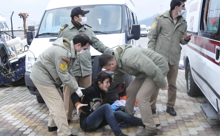 A migrant woman cries after being rescued by Turkish Coast Guard Saturday. The boat, packed with more than 100 migrants, sank close to the Turkish shore.