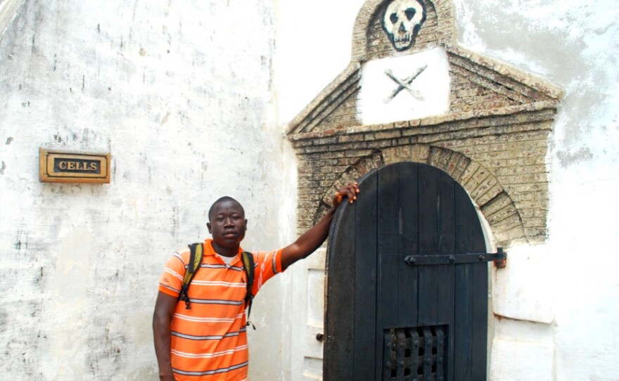 George Mwinnyaa on his visit to the slave castle at Cape Coast in his homeland of Ghana. The door leads to the cells where captives who were resistant were held prior to being sent over the ocean as slaves.