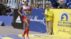 Meb Keflezighi, of San Diego, crosses the finish line in the 121st Boston Marathon on Monday, April 17, 2017.