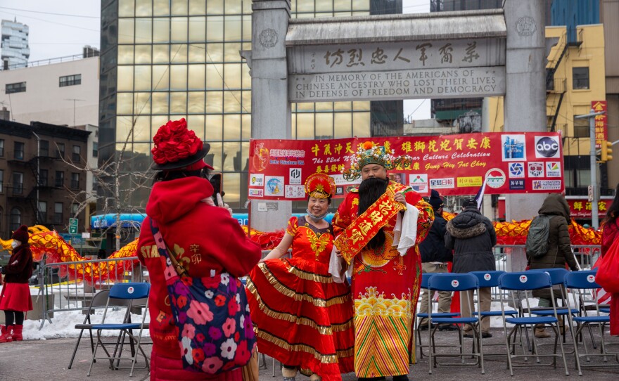 People take photos at the Lunar New Year celebration in Kimlau Memorial Square.