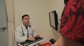 Dr. Chris Gordon meets with a patient at the Chase Avenue Family Health Center in El Cajon in 2013.