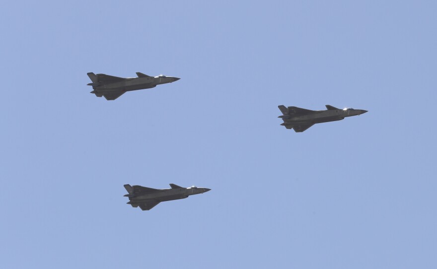 Chinese J-20 stealth fighter jets fly past during a military parade at the Zhurihe training base in China's northern Inner Mongolia region in July.