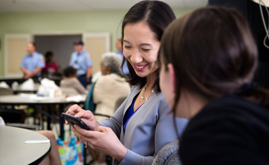Wen chats with a member of her staff at the Sandtown Winchester Senior Center.