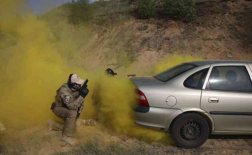Volunteers from Belarus practice at a shooting range near Warsaw, on May 20.