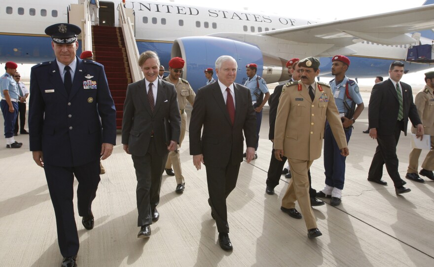 Then-U.S. Charge d'Affaires David Rundell (second left) walks on the tarmac with then-Defense Secretary Robert Gates and Saudi armed forces official Ibrahim Al-Malik, at Riyadh International Airport, Saudi Arabia, May 5, 2009. Gates was on a trip to discuss Washington's diplomatic approach to Iran.