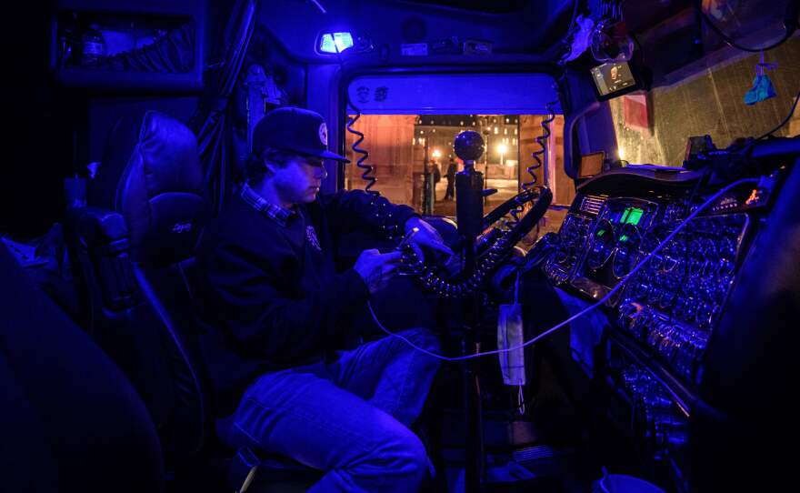 A man protests as he sits in the cab of his truck in Ottawa, during a demonstration by truck drivers over pandemic health rules and the Trudeau government. Millions of dollars that were donated to boost the protests are now in limbo.