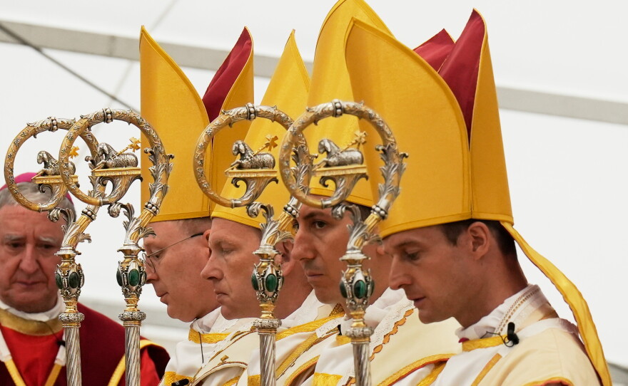 Newly consecrated Bishops, from left, Pascal Schreiber, Michael Goldade, Michel Poinsinet de Sivry and Marc Hanappier, wearing their miters and holding their pastoral staffs, pray at the end of their consecration ceremony in a tent set up outside the Society of St. Pius X seminary in Econe, Switzerland, Wednesday, July 1, 2026.