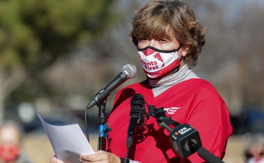 Longmont United Hospital nurse Kris Kloster speaks to other nurses and supporters December 2, 2021, outside the hospital. They say the hospital is severely understaffed, their workload is unsustainable, and the hospital is trying to block them from forming a union.