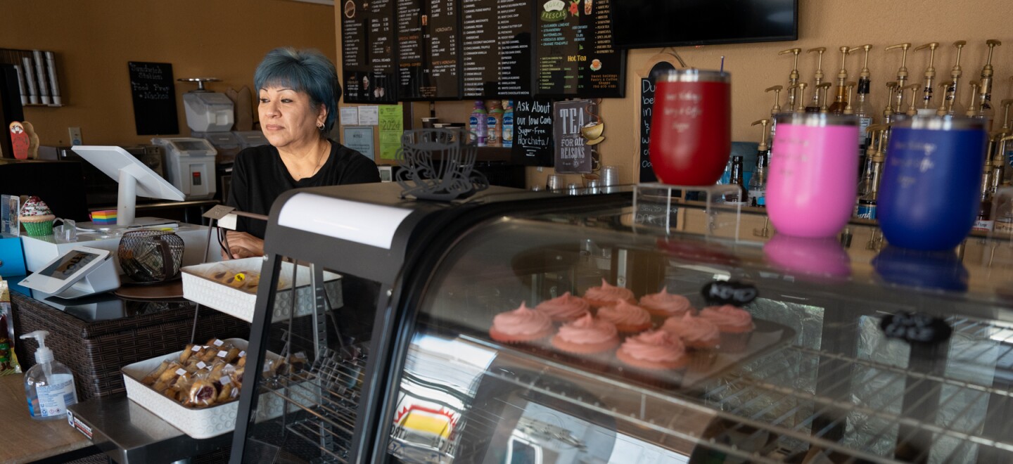 Elsa Ordona leans against the register awaiting her second rush at Sweet Nothings Pastry and Coffee Shoppe in El Centro, Calif. on June 5, 2024.