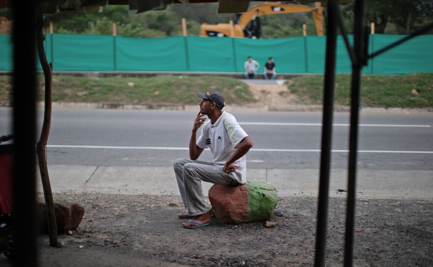 Oscar Martínez, one of more than four million Venezuelans who have left their country, rests at a roadside stand near Cucuta, Colombia.