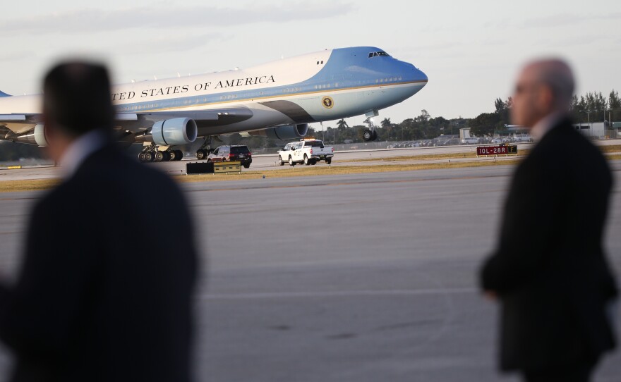 U.S. Secret Service agents stand on the tarmac as Air Force One lands in West Palm Beach, Fla., in February.