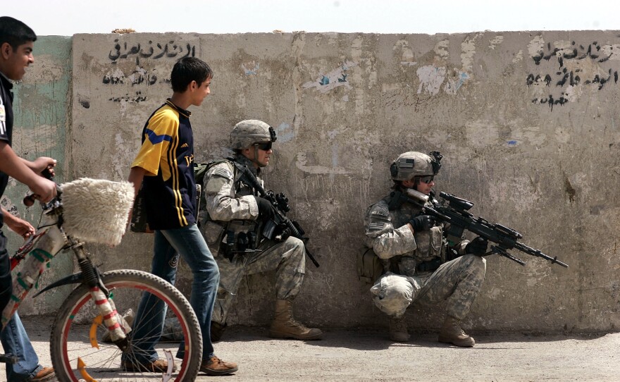 U.S. Army soldiers take up a position during a patrol in Baghdad in 2007. The U.S. has been waging war nonstop for 15 years since the Sept. 11 attacks. Despite the protracted conflicts and disappointing results, U.S. involvement in multiple wars appears set to continue for years to come.