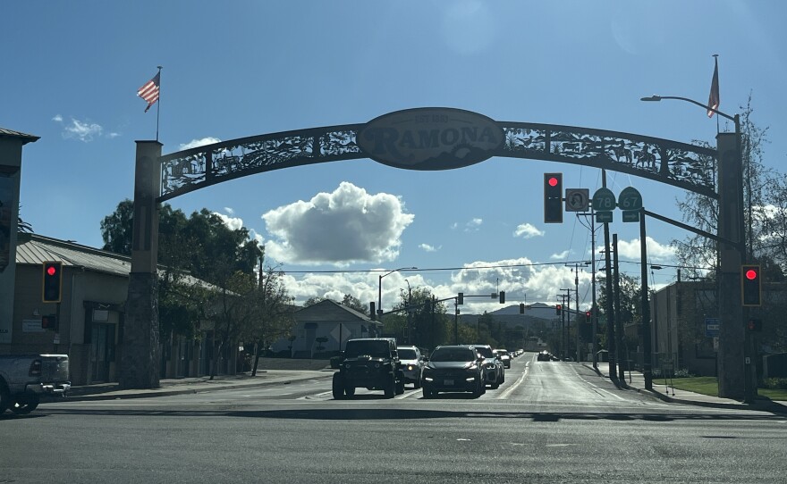 Cars pass under the Ramona sign in the city's downtown area, Nov. 19, 2025.
