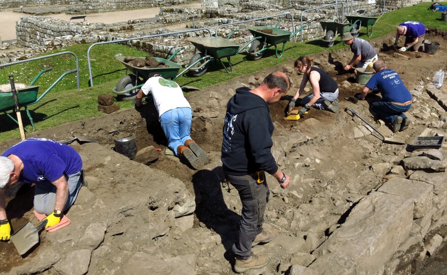 Andrew Birley (standing in center front), director of excavations, works among volunteer archaeologists at Vindolanda in northern England. For close to a century, the Birley family has led excavations at the 2,000-year-old Roman site.