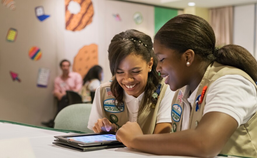 In this undated photo released by the Girl Scouts of the USA, Girl Scouts Bria and Shirell practice selling cookies on one of two new digital platforms. It's the first time the organization has allowed the sales of cookies using a mobile app or personalized websites.