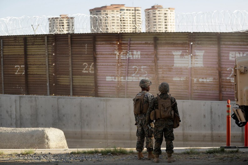 Marines look on during work to fortify the border structure that separates Tijuana, Mexico, behind, and San Diego, near the San Ysidro Port of Entry in San Diego, Friday, Nov. 9, 2018. 