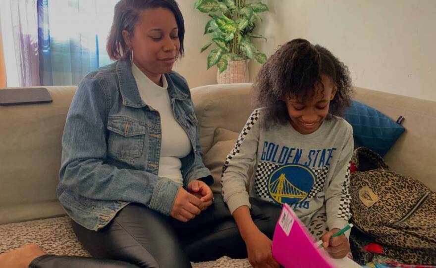 Ta’Kira Dannette Byrd, 11, sits on the couch of her Vallejo home with her mother, Shawntierra Dolton.