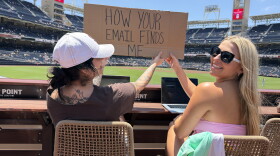 Fans hold a sign reading "How your email finds me" at the Padres game